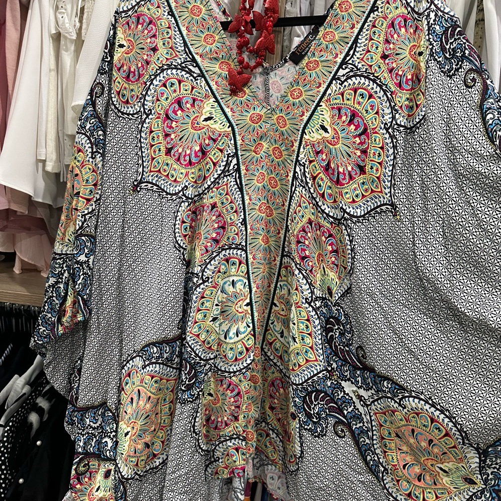 Oversized shirt ! Very casual , great for swim coverup or jeans .